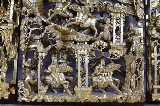 Six Chinese carved giltwood panels of soldiers amid pavilions